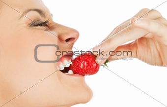 Woman biting strawberry
