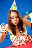Woman blowing birthday candles