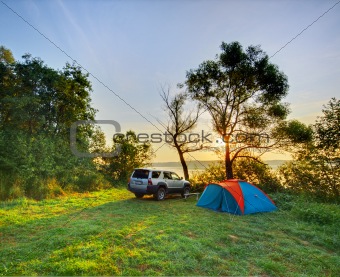 Automobile and camp on sunrise