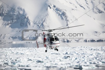 Helicopter rescue action over the Arctic fjord