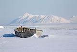 Very old wooden boat on the Arctic shore