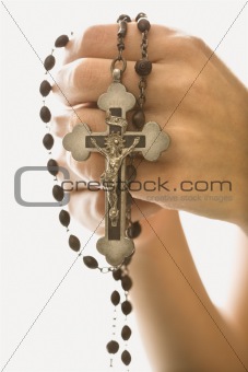 Woman holding crucifix.
