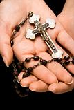 Hands holding rosary.