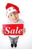 Standing boy holding sale sign