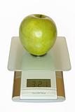 Big green apple on electronic kitchen scales
