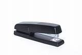 Black office stapler isolated on white background