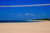 Blue sky through  volleyball net on the beach