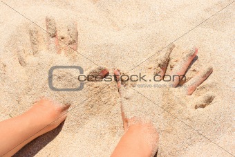 Hands buried in sand