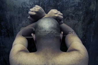 prisoner against wall inside a jail