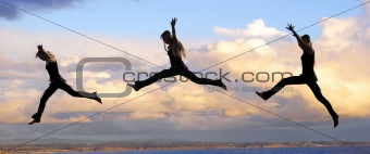 Leaping woman at sunset