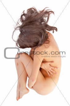 naked woman lying in a fetal position