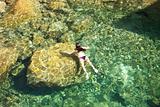 woman swimming on the rocks