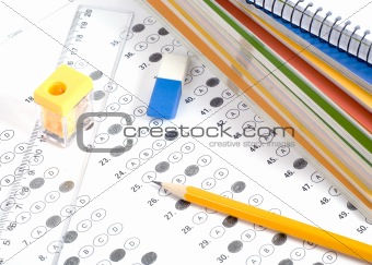 Test score with pencil, notebook and eraser