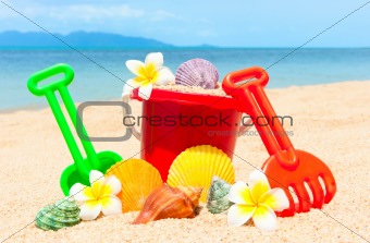 Spade and other toys on tropical beach