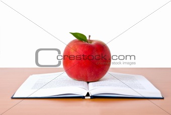 Books tower with apple isolated on white