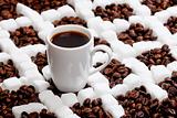 cup of coffee with coffee beans and sugar
