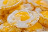Stack of fried eggs focus on the center egg yolk
