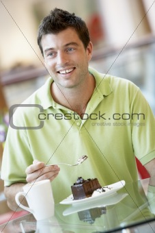 Man Eating A Piece Of Cake At The Mall