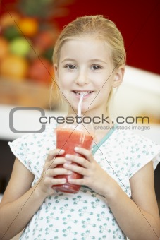 Young Girl Drinking A Berry Smoothie