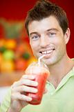 Man Drinking A Berry Smoothie