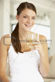 Young Woman Enjoying A Glass Of White Wine