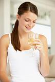 Young Woman Enjoying A Glass Of White Wine