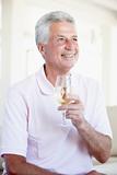 Man Enjoying A Glass Of White Wine