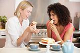 Female Friends Enjoying Tea And Cake At Home