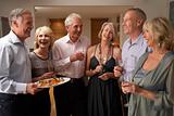 Man Serving Hors D'oeuvres To His Guests At A Dinner Party