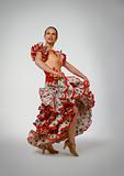 Young woman dancing flamenco with castanets