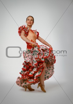 Young woman dancing flamenco with castanets