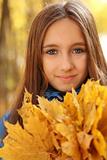 Portrait of a happy teen girl in autumn forest