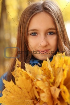 Portrait of a happy teen girl in autumn forest