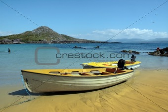 yellow boats on golden irish beach