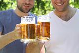 Two men with glasses of the light beer i