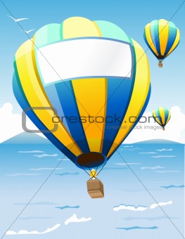 Hot air balloons floating at sea coast