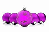 Purple christmas baubles on white background with space for text