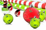 Rolls of gift wrapping paper and ribbon with red and green christmas baubles