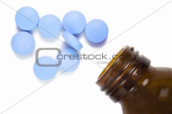 Pill and pill bottle on white background with space for text