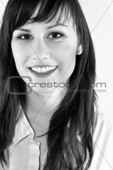 Closeup portrait of cute young girl smiling against white backgr