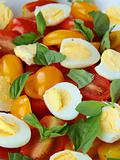 salad with quail eggs and cherry tomatoes close up