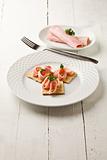 Crackers canapes with ham and parsley