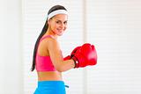 Smiling fit girl in boxing gloves
