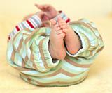 Cute baby foots in striped pants