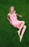 Young attractive blond girl on the green grass