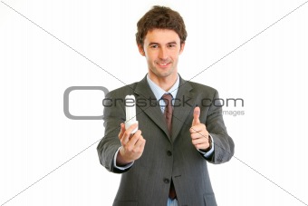 Modern businessman with fluorescent lamp showing thumbs up gesture. Environmental protection concept
