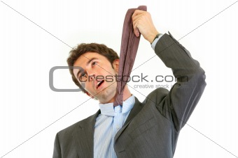 Stressed businessman hanging himself on his necktie
