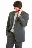 Concerned businessman talking on phone
