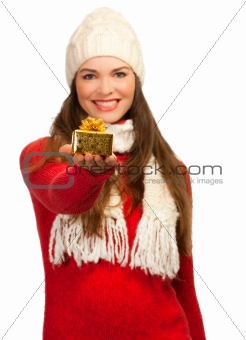 Beautiful woman holding small golden gift