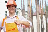 Smiling young worker with thumb up